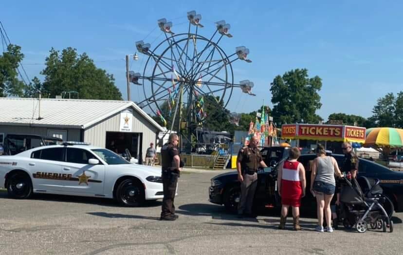 Officers and kids at fair
